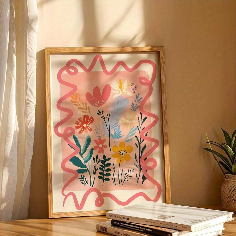 Close view of framed colorful floral illustration with coral wavy border styled on a table