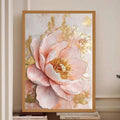 Framed blush peony canvas displayed above books on a light console