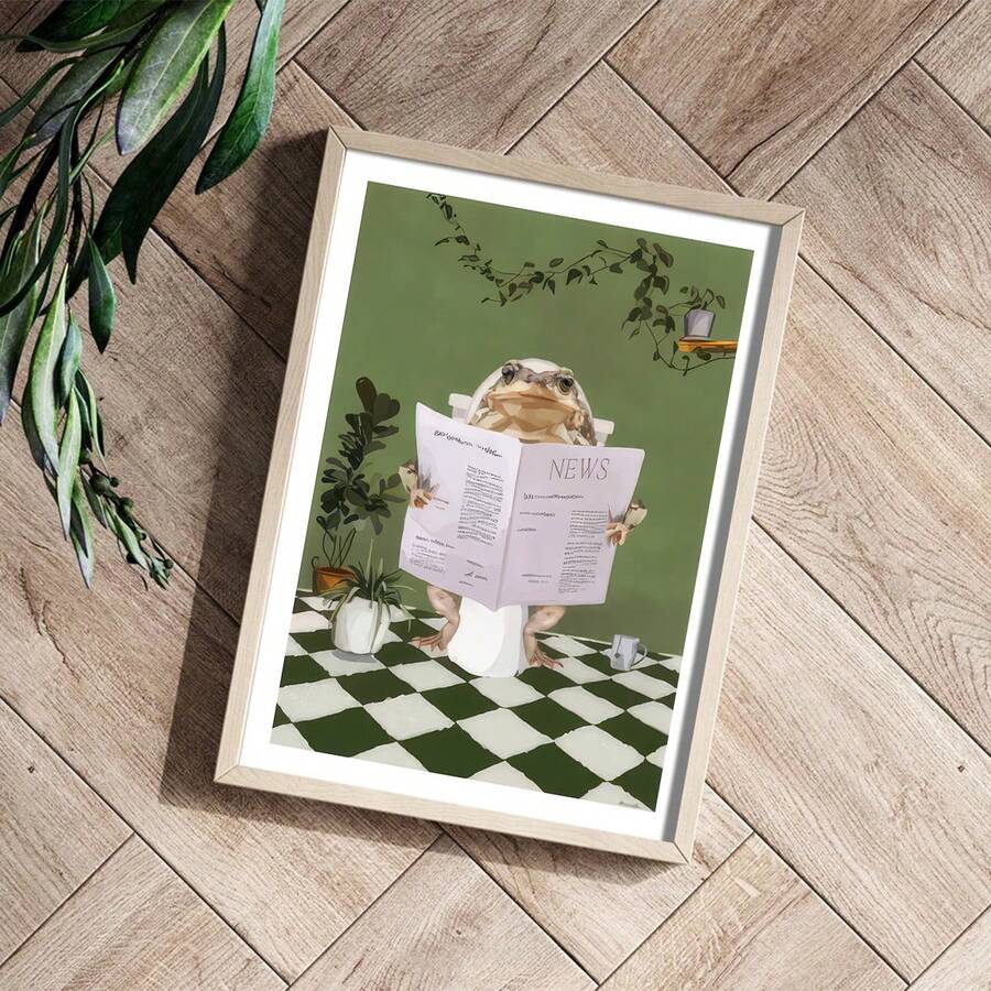 Angled view of green frog newspaper artwork in a light wood frame
