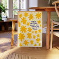Yellow wildflower quote canvas displayed beside a wooden dining table