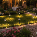 Lawn decor solar projector installed in grass with moon star firework pattern