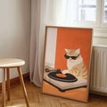 Cat DJ print in light wood frame leaning by window and radiator
