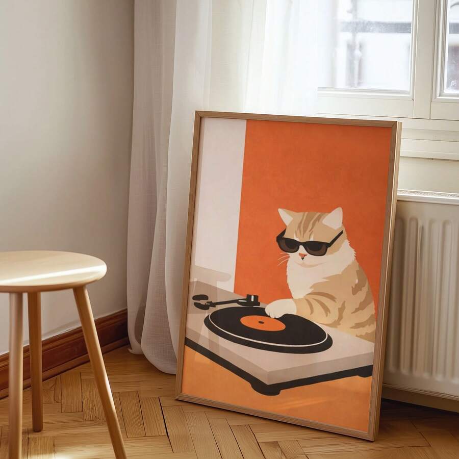 Cat DJ print in light wood frame leaning by window and radiator