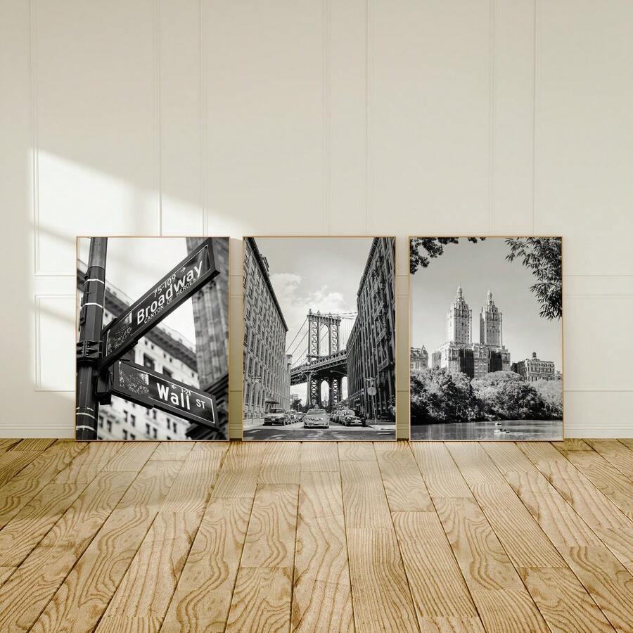 Three framed black and white New York prints above modern sideboard
