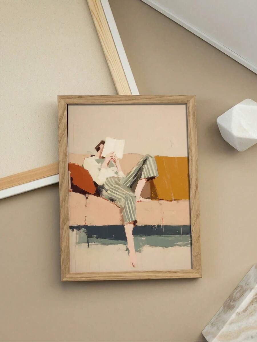 Wood framed reader figure print flat lay on neutral floor