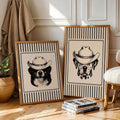 Cowboy dog framed print set beside chair and stacked books