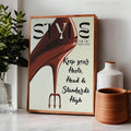 Framed red stiletto STYLE poster on white tabletop beside plant vase and terracotta pot