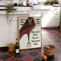 Red high heel fashion poster leaning in kitchen with wood frame apples wine bottle and jar