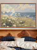 room mockup view of Coastal meadow canvas wall art showing white wildflowers, ocean horizon, blue sky, soft clouds and airy impressionist cottage colors.