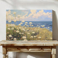 lifestyle wall display of Coastal meadow canvas wall art showing white wildflowers, ocean horizon, blue sky, soft clouds and airy impressionist cottage colors.