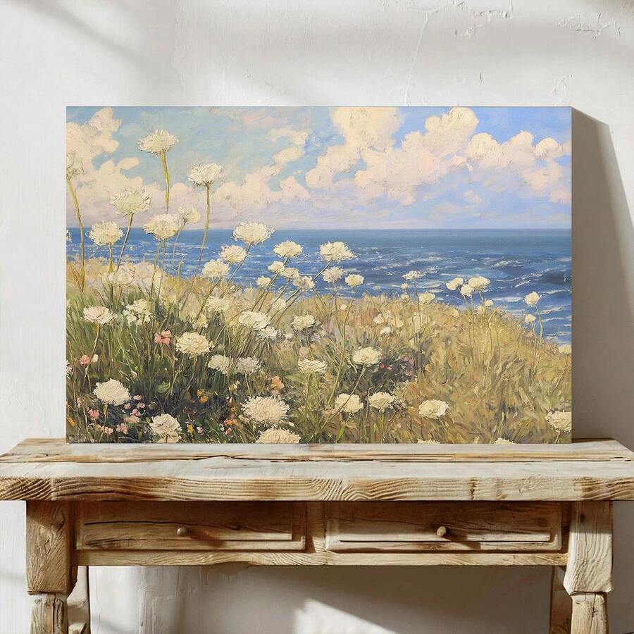 lifestyle wall display of Coastal meadow canvas wall art showing white wildflowers, ocean horizon, blue sky, soft clouds and airy impressionist cottage colors.