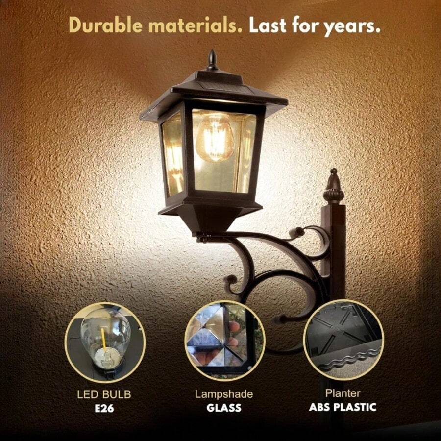 Black solar lamp post with planter lit beside front porch decor.