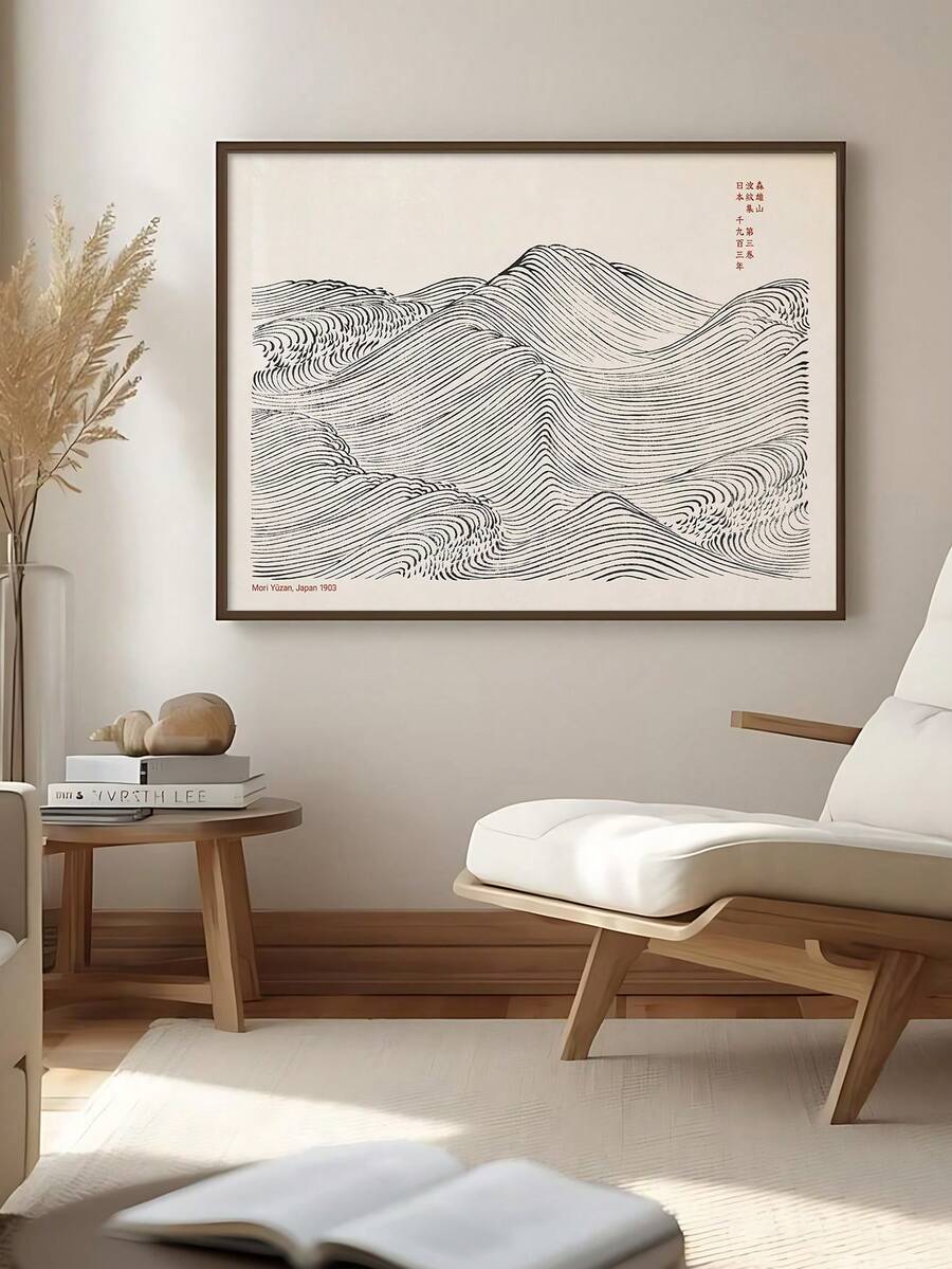Framed Japanese wave line art poster above lounge chair in neutral Japandi room