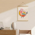 Funny bird wall scroll displayed above a sideboard