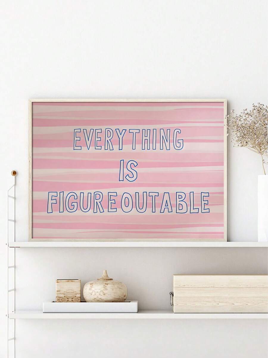 Pink striped Everything Is Figureoutable framed quote wall art beside sofa