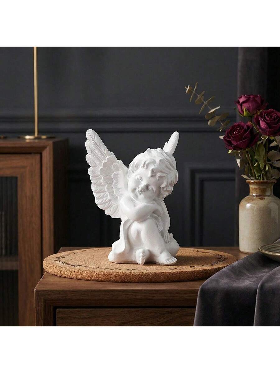 Glossy white cherub figurine with detailed curls, face, toes, and feathers.