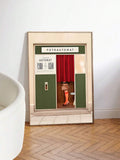 Retro FOTOAUTOMAT fashion poster leaning near a lounge chair and herringbone floor
