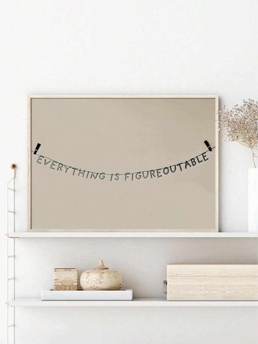 Quote wall art over console with Everything is figureoutable text and light wood frame