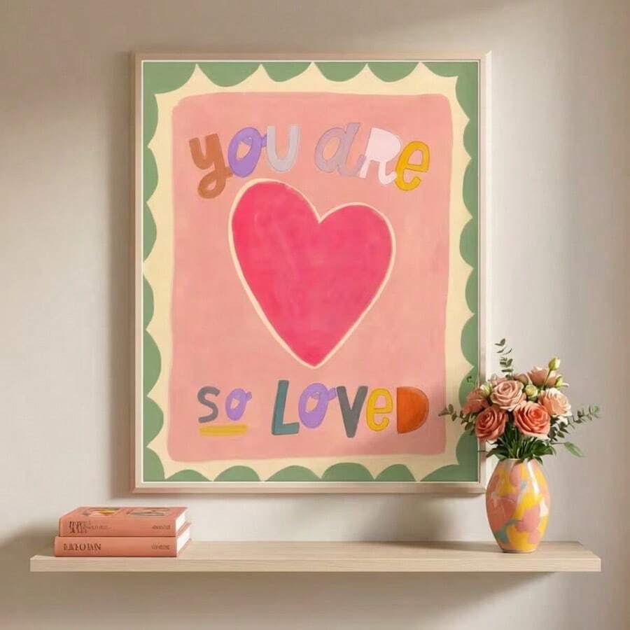 Framed pastel affirmation print reading you are so loved above crib and toys