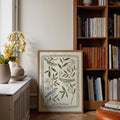 Folk art bird poster styled beside books and flowers