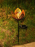 Single garden stake light installed in grass with black spike and side solar panel