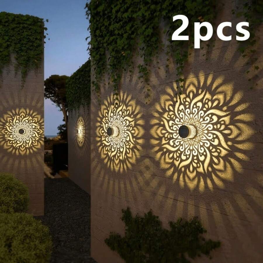 Two solar mandala fence wall lights projecting colorful floral patterns.