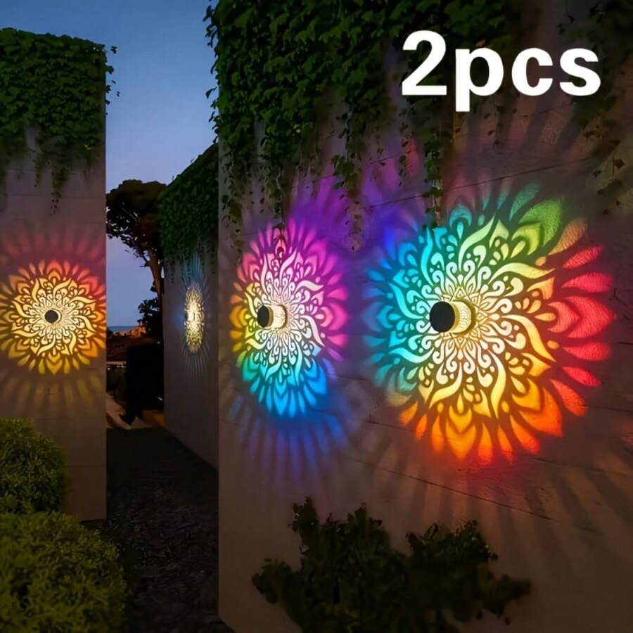 Two solar mandala fence wall lights projecting colorful floral patterns.