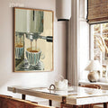 Espresso machine canvas poster above a bright dining table with rattan chairs and a woven window blind