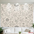 Minimal floral wall hanging displayed above sofa in neutral living room