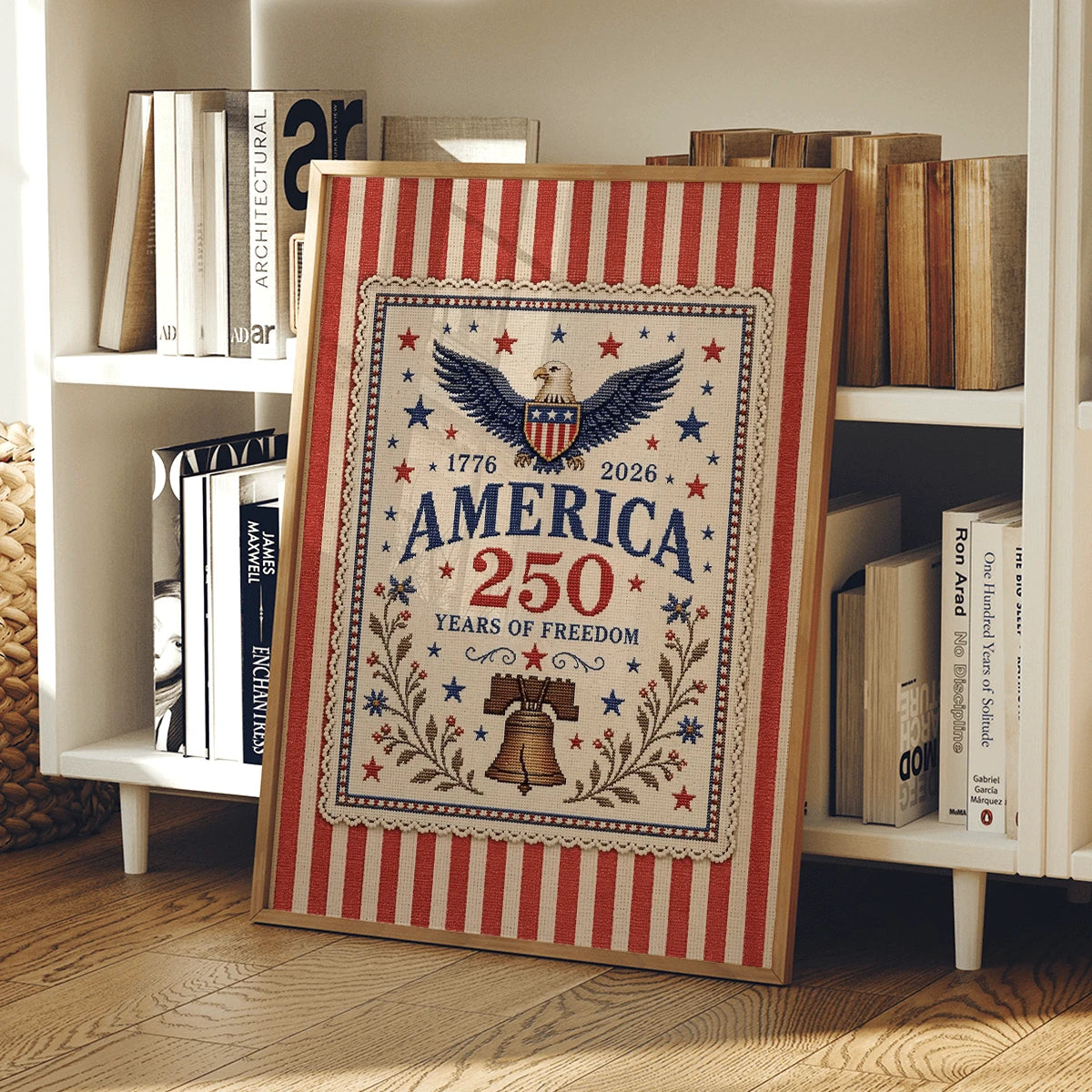Vintage patriotic canvas print in a light wood frame beside books