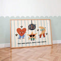Playful framed nursery print with heart star moon and dance quote against blue wall