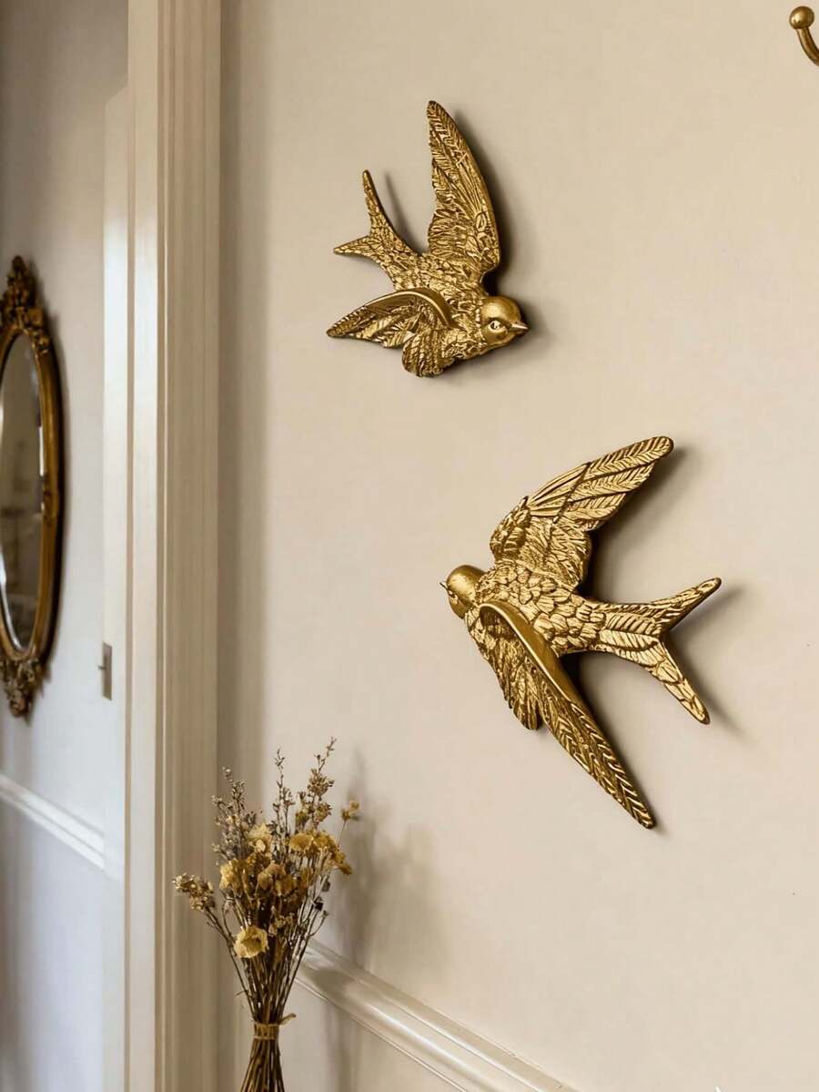Gold bird pendant wall decor with raised feather and wing details.