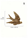 Size graphic showing S gold bird decor about 11.2 cm wide and 9 cm high.