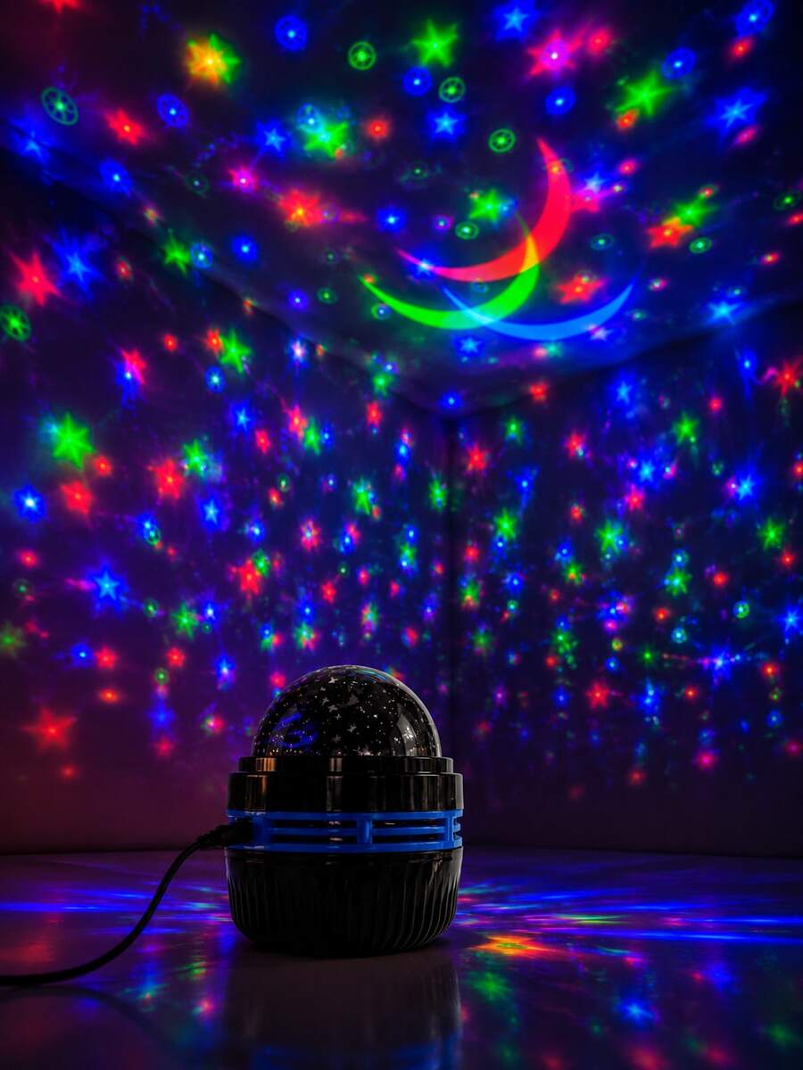 USB star and moon rotating projector lamp casting multicolor ceiling patterns.