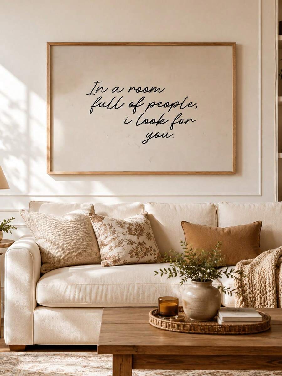 Black script quote poster displayed over a neutral sofa and cushions