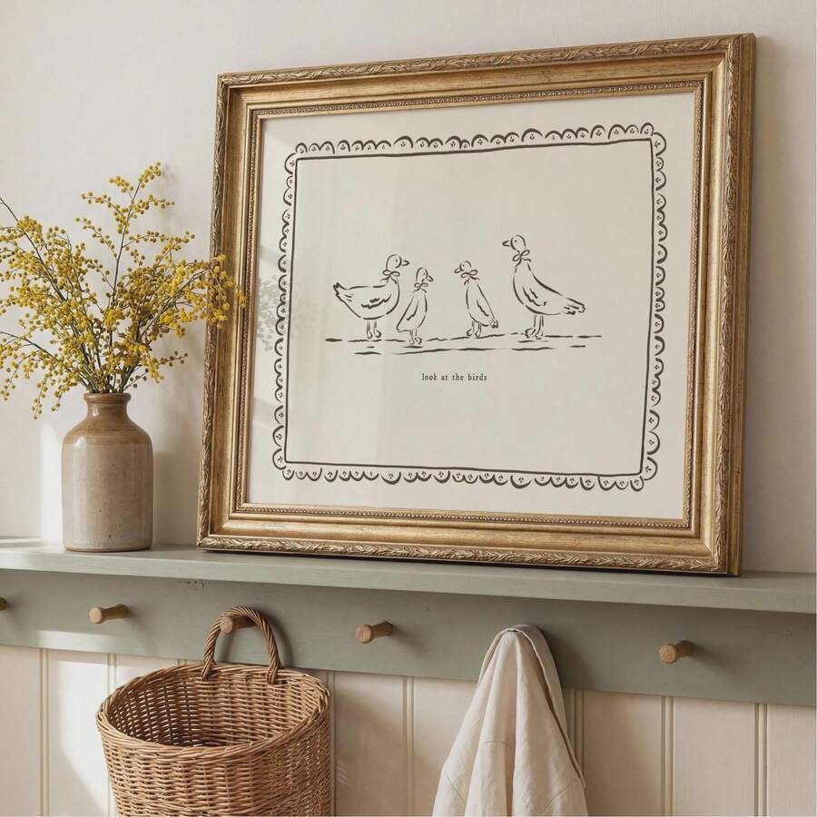 Neutral animal wall art leaning on wooden shelf