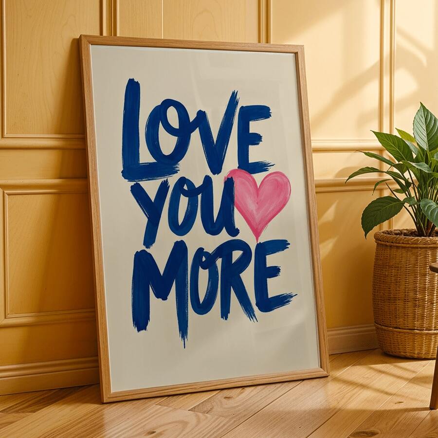 Framed Love You More canvas poster against golden paneled wall