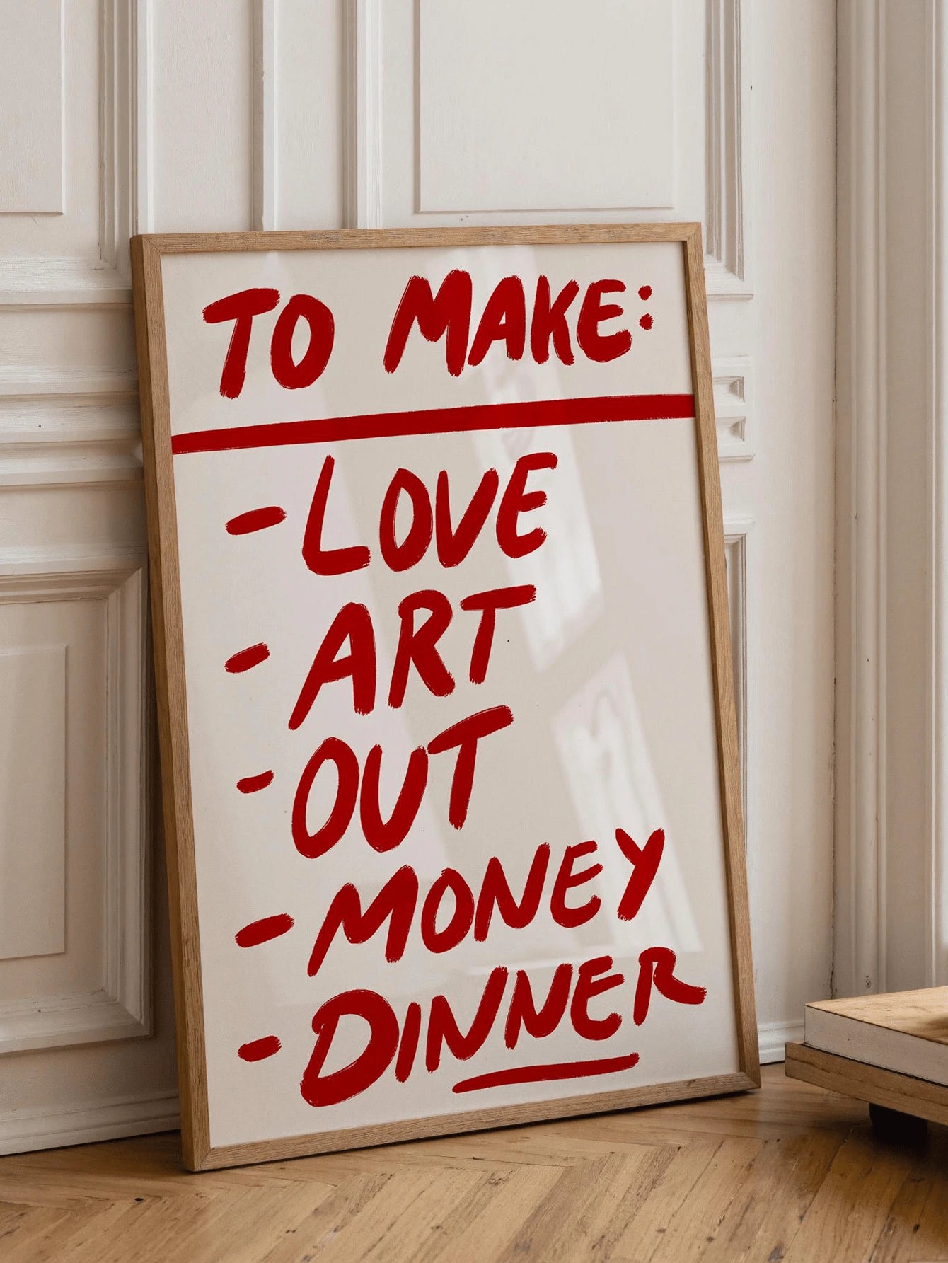 Red script wall art styled in kitchen with oranges