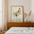 Vintage botanical art showing soft butterfly and floral stem on cream background