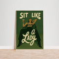 Retro green feminist poster showing woman seated boldly with text Sit Like A Lady