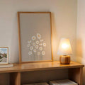 Wood framed daisy poster on desk