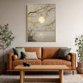 Light framed full moon landscape print above brown leather sofa in neutral living room with plants