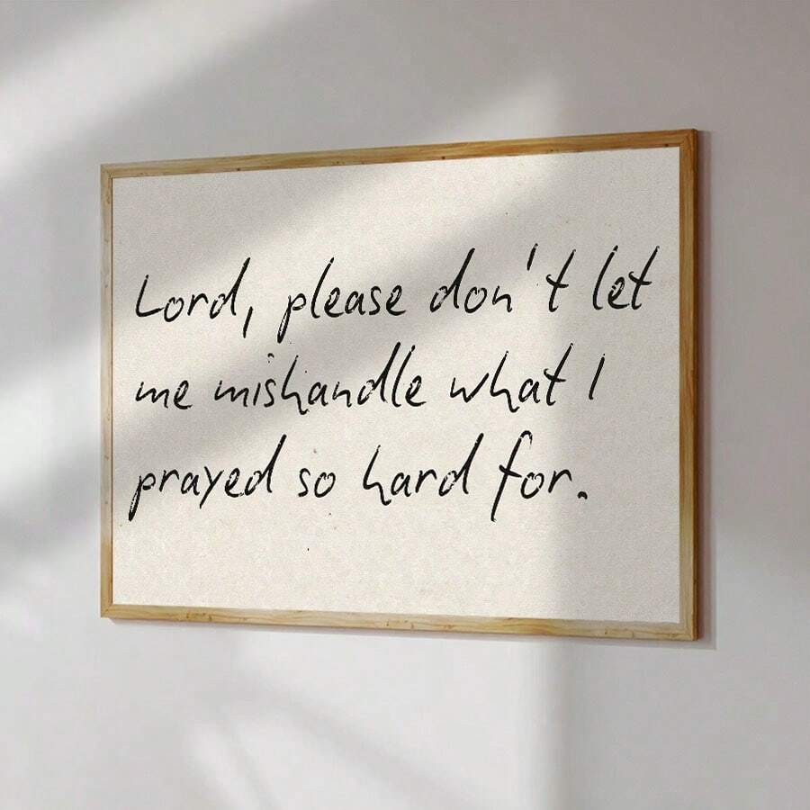 Religious quote print in black script on cream neutral background with light wood frame