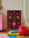 Framed love poster leaning on shelf with floral and heart artwork