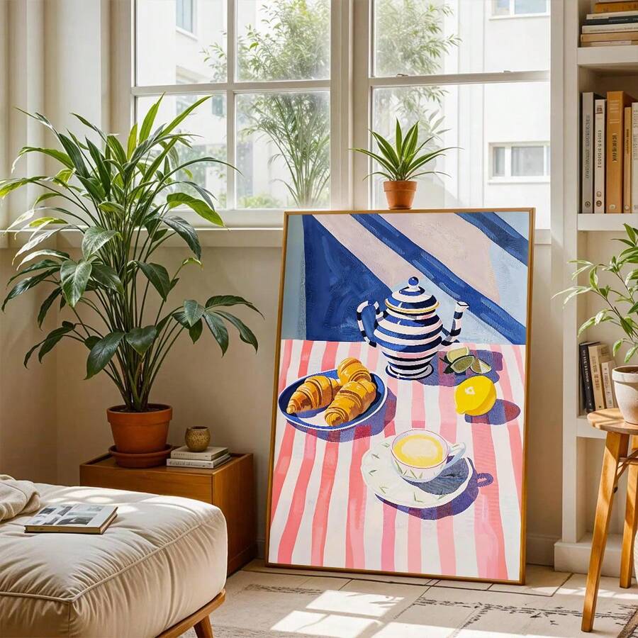 Framed cafe breakfast art leaning by window with plants and books in bright living space