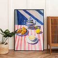 Black framed teapot croissant kitchen wall art beside plant basket and wooden cabinet