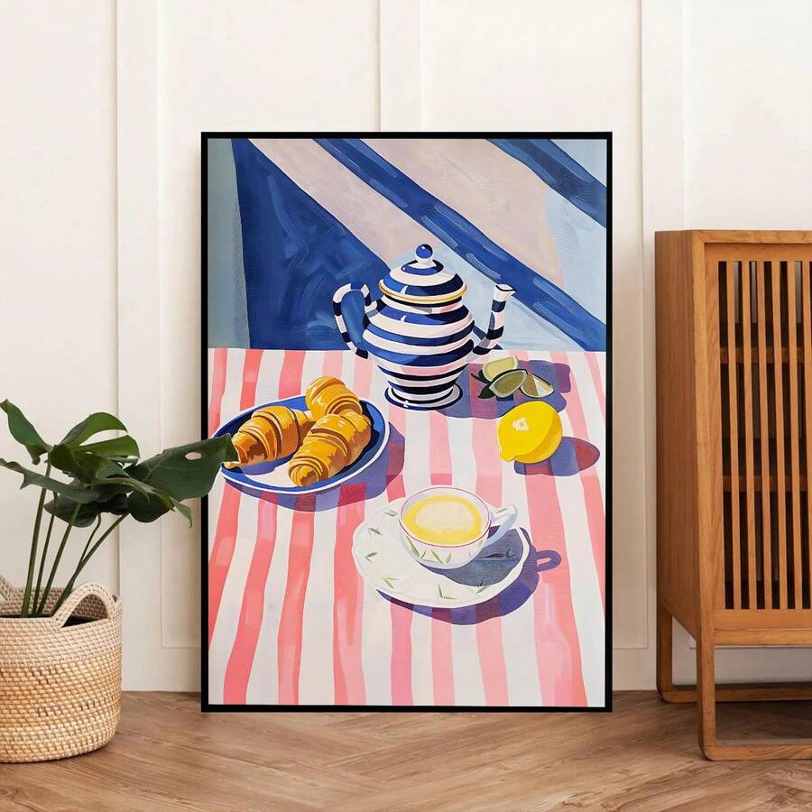 Black framed teapot croissant kitchen wall art beside plant basket and wooden cabinet