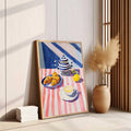 Natural wood framed breakfast still life leaning beside pampas vase in warm neutral room