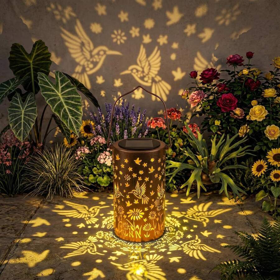 Bronze outdoor hanging lantern with hummingbird cutouts on patio steps.
