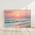 canvas option view of Framed coastal wall art print showing ocean waves, beach shoreline, sunrise or sunset sun, pastel sky and soft modern beach house colors.